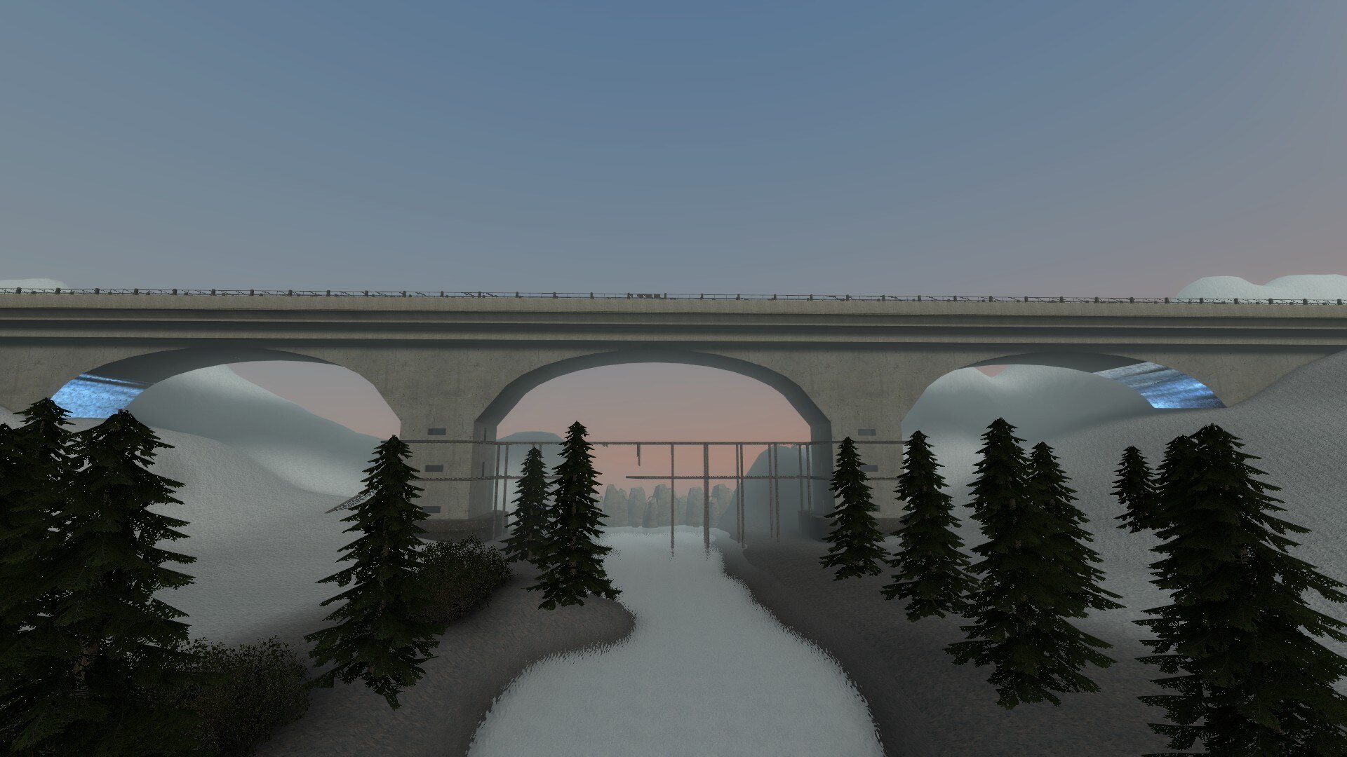 A huge concrete bridge crossing the snowy valley